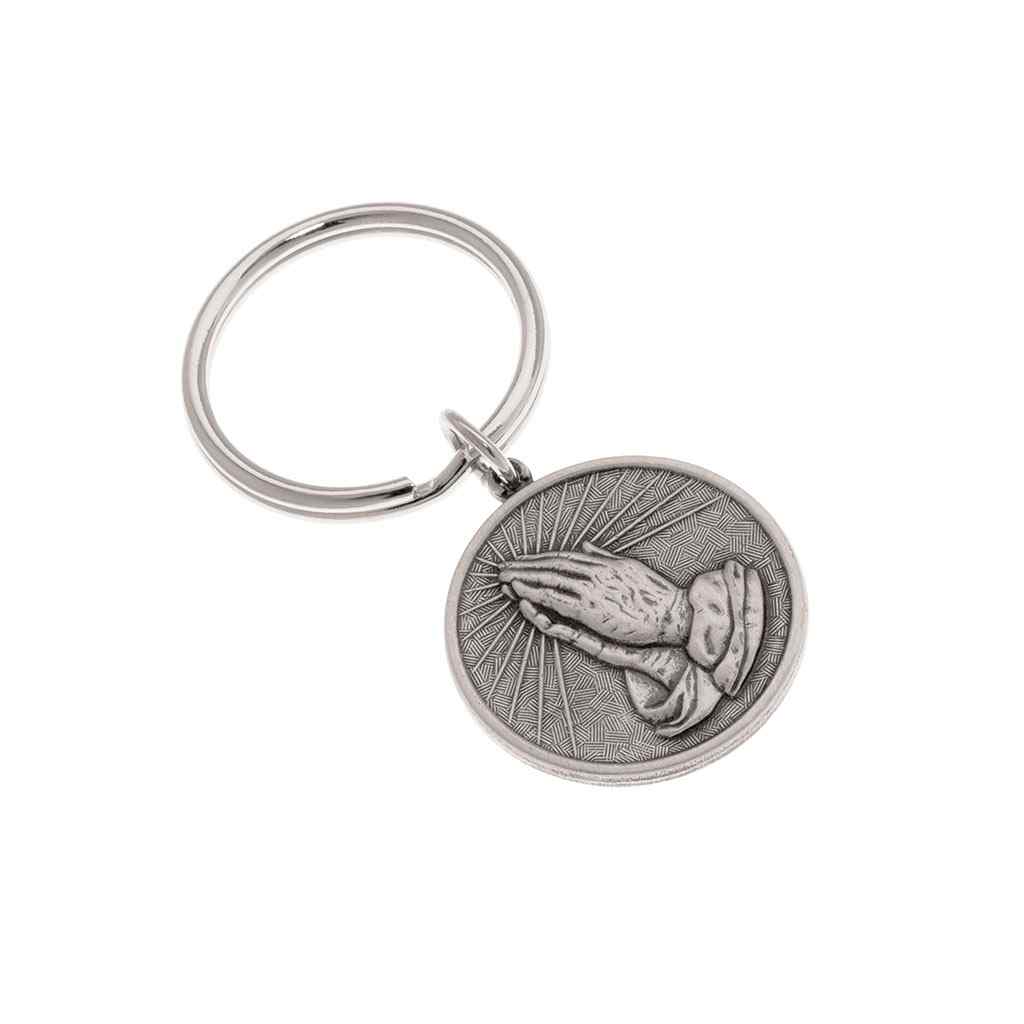 A round praying hands key ring with serenity prayer displayed on a neutral white background.